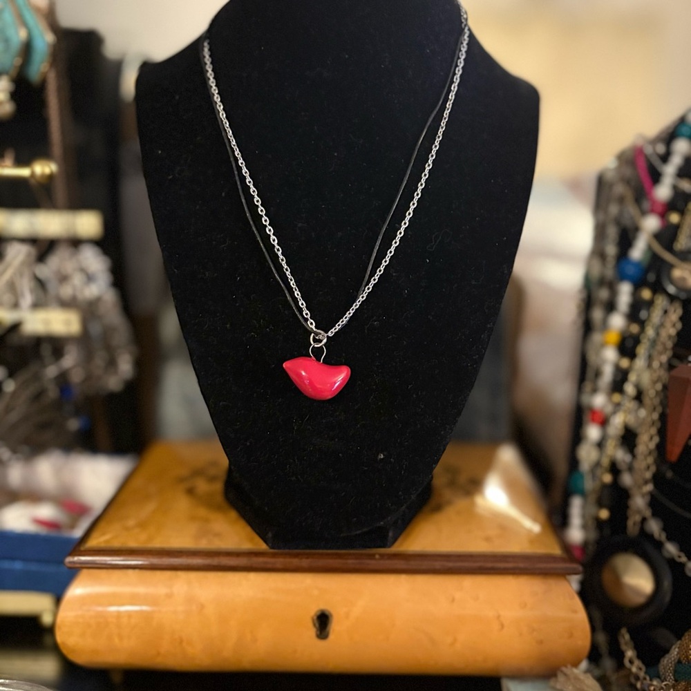 Red Bird Pendant on a Leather and Silvertone Chain.